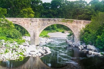 Fototapeta na wymiar A view of Devils Bridge, a famous landmark on the river Lune near Kirkby Lonsdale, Cumbria, UK