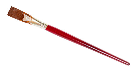 flat paint brush with brown colored tip and brown handle isolated on white background