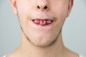 Close up of a young man, folding his tongue in a rare tri fold, clover leaf shape. Strange genetic ability