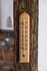 Thermometer on wooden background. Wooden thermometer