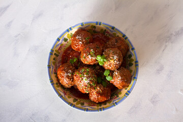 Meatballs in bowl on white background. View from above, top view