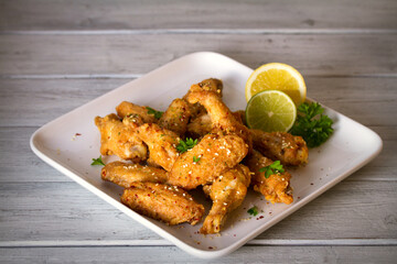 Deep fried chicken wings on white plate. Horizontal image