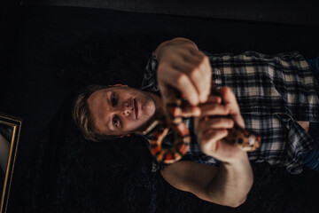 Beautiful tortoise snake in her arms.