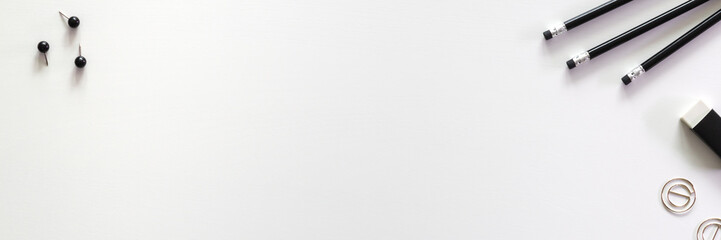 Office desk with scattered utensils. Black and white. Panorama