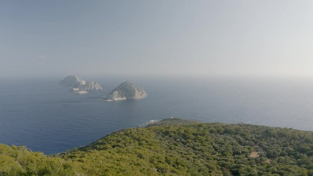 Small Greek islands from above. Beautiful landscape with mountains. Mediterranean sea. Aerial view 4K.