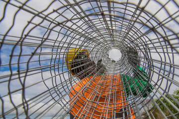 
man carrying roll of wire fence