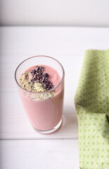 Strawberry raspberry smoothie with hemp seed and cocoa bean topping in the glass