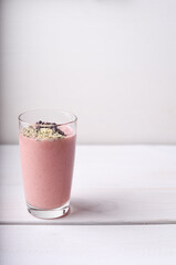 Strawberry raspberry smoothie with hemp seed and cocoa bean topping