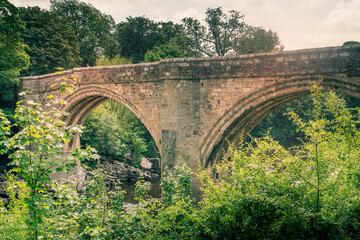 Fototapeta na wymiar A view of Devils Bridge, a famous landmark on the river Lune near Kirkby Lonsdale, Cumbria, UK