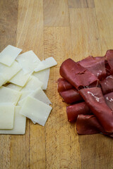 Rolled slices of bresaola, delicious typical italian raw beef salami, with grana padano cheese...