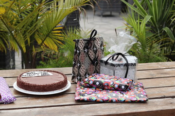 birthday cake on a table with gifts