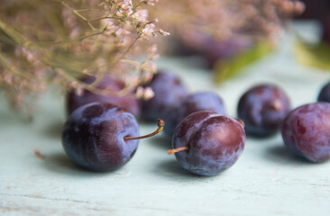 Plum. Fresh plum. Harvest. Autumn harvest. Autumn. Blue plums. Fresh plums on a wooden surface....