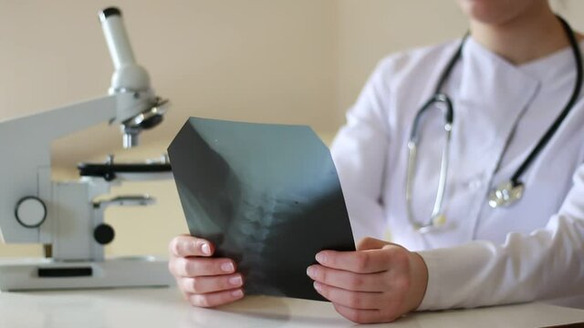 Doctor examines X-rays of the cervical vertebrae