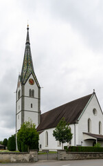 view of the historic catholic church Saint Maurice in the Swiss village of Sommeri