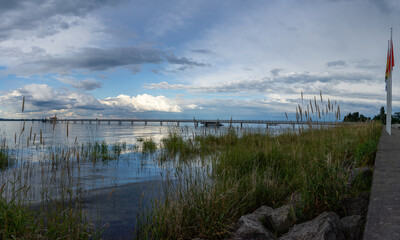 Obraz premium view of Lake Constance with the pier at Altnau in evening light