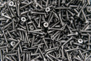 Background of metal nails top view close-up. Background from a variety of building steel sharp nails macro. A big pile of nails. Гвозди. Шурупы. 