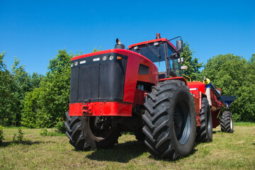 Tractor New Holland, on the field in the Russian village, on a Sunny day and blue sky. Russia. Tatarstan. 8 July 2019. Agricultural machinery.