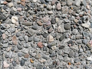 Stone pattern wall with lots of pebbles in different colors, patterns and textures