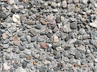 Stone pattern wall with lots of pebbles in different colors, patterns and textures