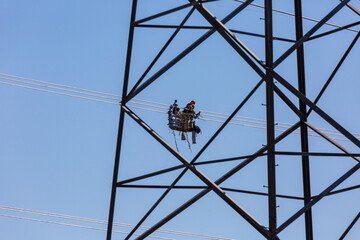 Line workers installing spacer dampers on high voltage power conductors.  Several scenes shot at each location to capture this detailed task.