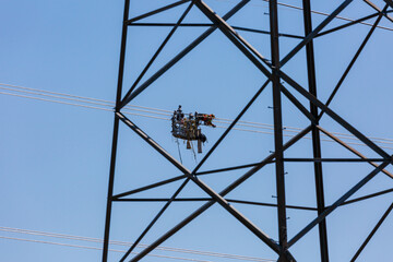Line workers installing spacer dampers on high voltage power conductors.  Several scenes shot at each location to capture this detailed task.