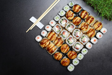 Sushi. Bonito rolls, classic and bake rolls on the dark background. Sushi food photo for menu. Combo set of rolls Sushi