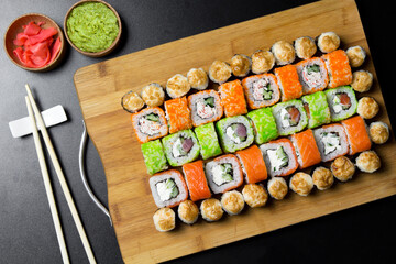 Sushi Philadelphia rolls, California, Miami rolls and bake the classic rolls on Board made of bamboo. Sushi food photo for menu. Combo set of rolls Sushi