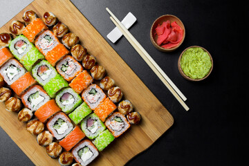 Sushi Philadelphia rolls, California, Miami rolls and bake the classic rolls on Board made of bamboo. Sushi food photo for menu. Combo set of rolls Sushi