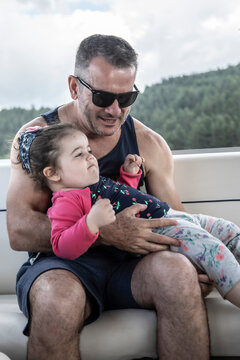 
father and daughter during boat trip on the lake in Sila National Park, Calabria, Italy
