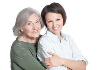 Mother and her adult daughter hugging isolated on white