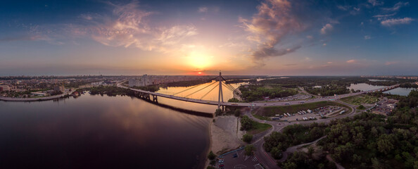 Aerial panorama of Kyiv at the sunset, sunset over Dnieper and bridge Pivnichny, Ukraine