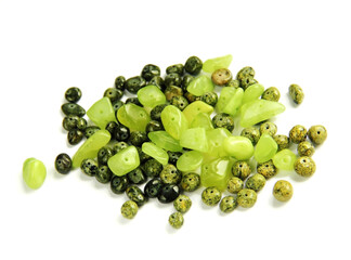 Group of light and dark green stones fnd serpentine marble beads isolated on white background