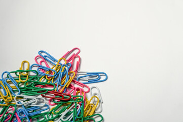 colorful paper clips on white background