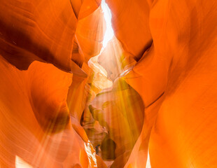 Shafts of light flicker across the canyon passage in lower Antelope Canyon, Page, Arizona