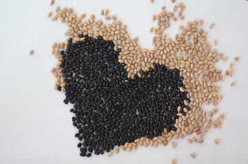 Black and white beans. Heart spilled seeds.