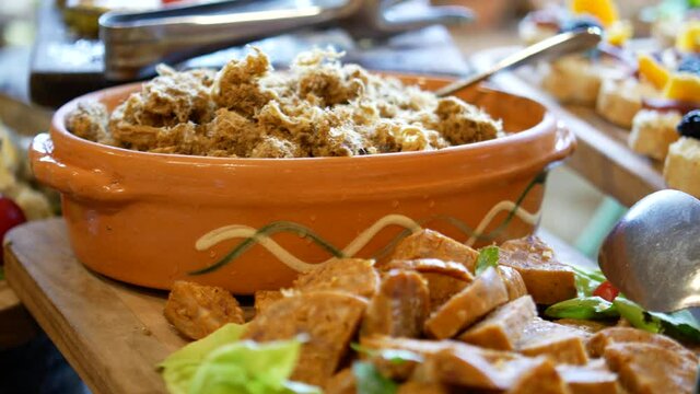 traditional serbian breakfast and apetizer, appetizer on the self-service table in the hotel, plates with cheese, cracklings, olives and canapes 