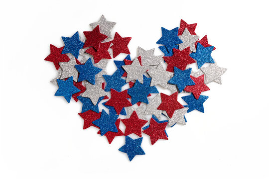American color stars in heart shape on white background. Flat lay, top view.