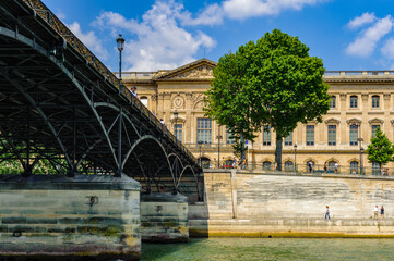 It's Pont des Arts or Passerelle des Arts, a pedestrian bridge in Paris which crosses the Seine River.