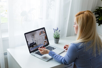 Female person sitting front open laptop computer, modern businesswoman work in internet via notebook, student
