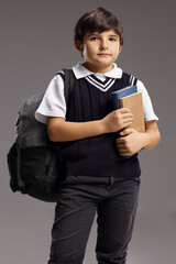 Schoolboy with a backpack and books