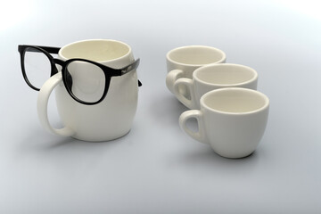 Celebration background for happy father's day. Creative breakfast with funny face made from a cups of coffee and glasses.