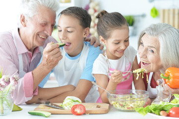 Portrait of family cooking together in kitchen