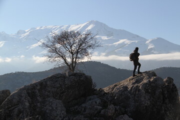 A hiker in the mountains, a hiker climbing a mountain, a hiker with a backpack on the mountains