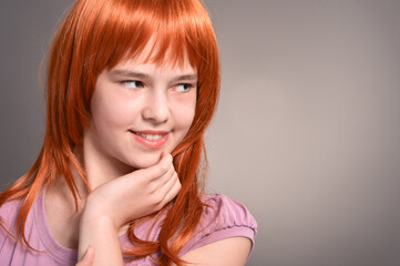 Fototapeta premium Portrait of cute girl with red hair posing