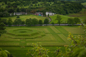 Fototapeta na wymiar Tilt shift effect of creatively landscaped green meadows in the Scottish countryside, Stirling. Concept: typical Scottish landscapes