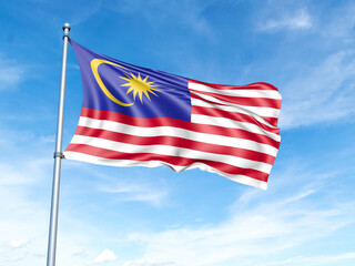 Malaysia flag on a pole against a blue sky background.