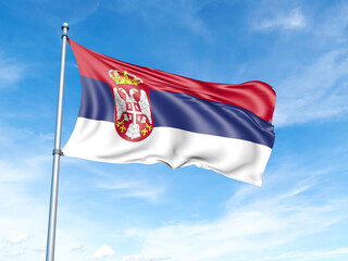 Serbia flag on a pole against a blue sky background.