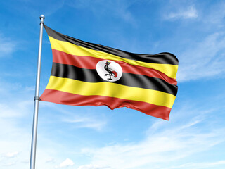 Uganda flag on a pole against a blue sky background.