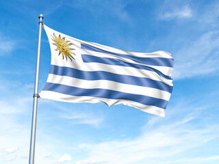Uruguay flag on a pole against a blue sky background.