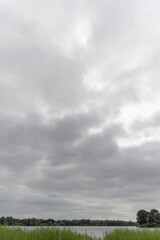 Obraz na płótnie Canvas storm clouds over the lake